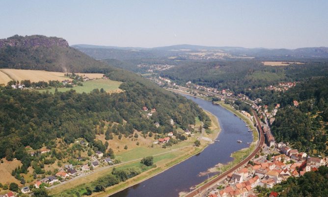 Aerial view of a river with a town alongside. Destination access reviews